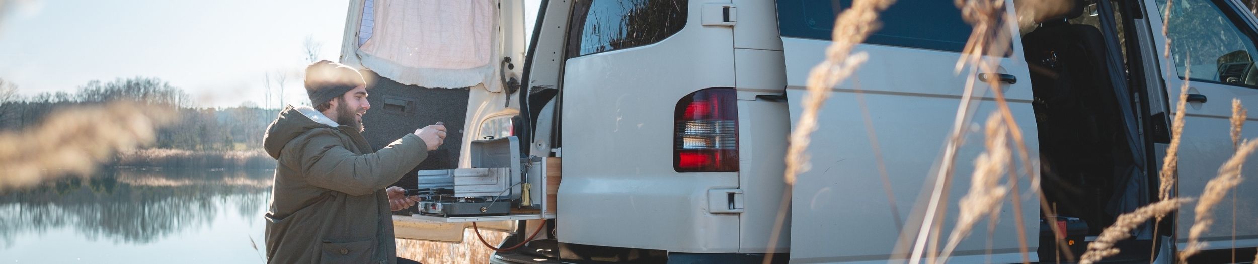 Man beside lake with his van conversion