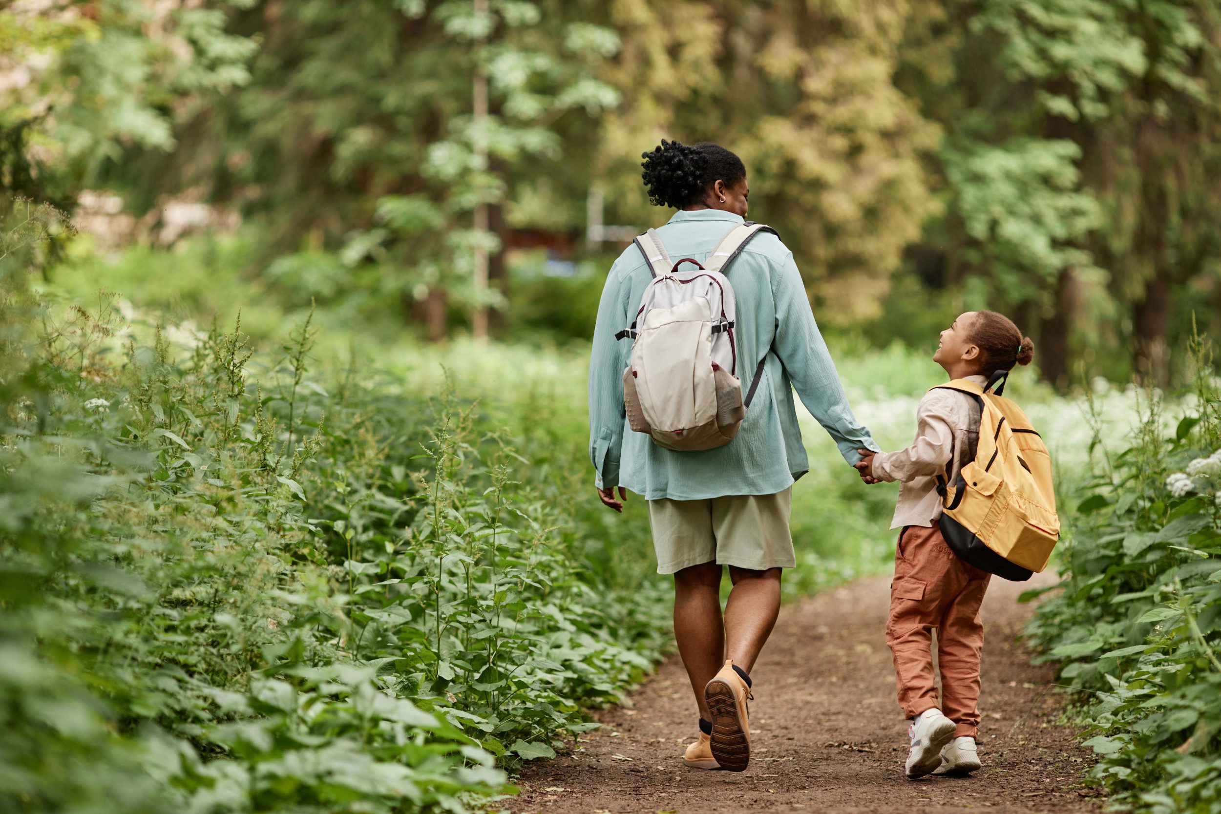 Mother and daughter walking in woodlands